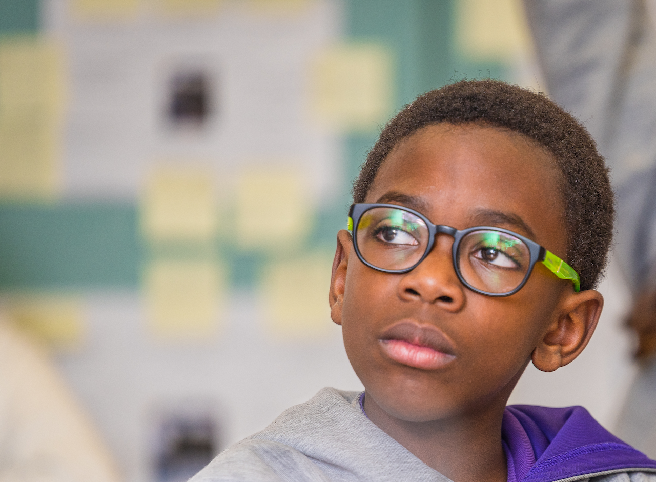 student wearing uniform and glasses