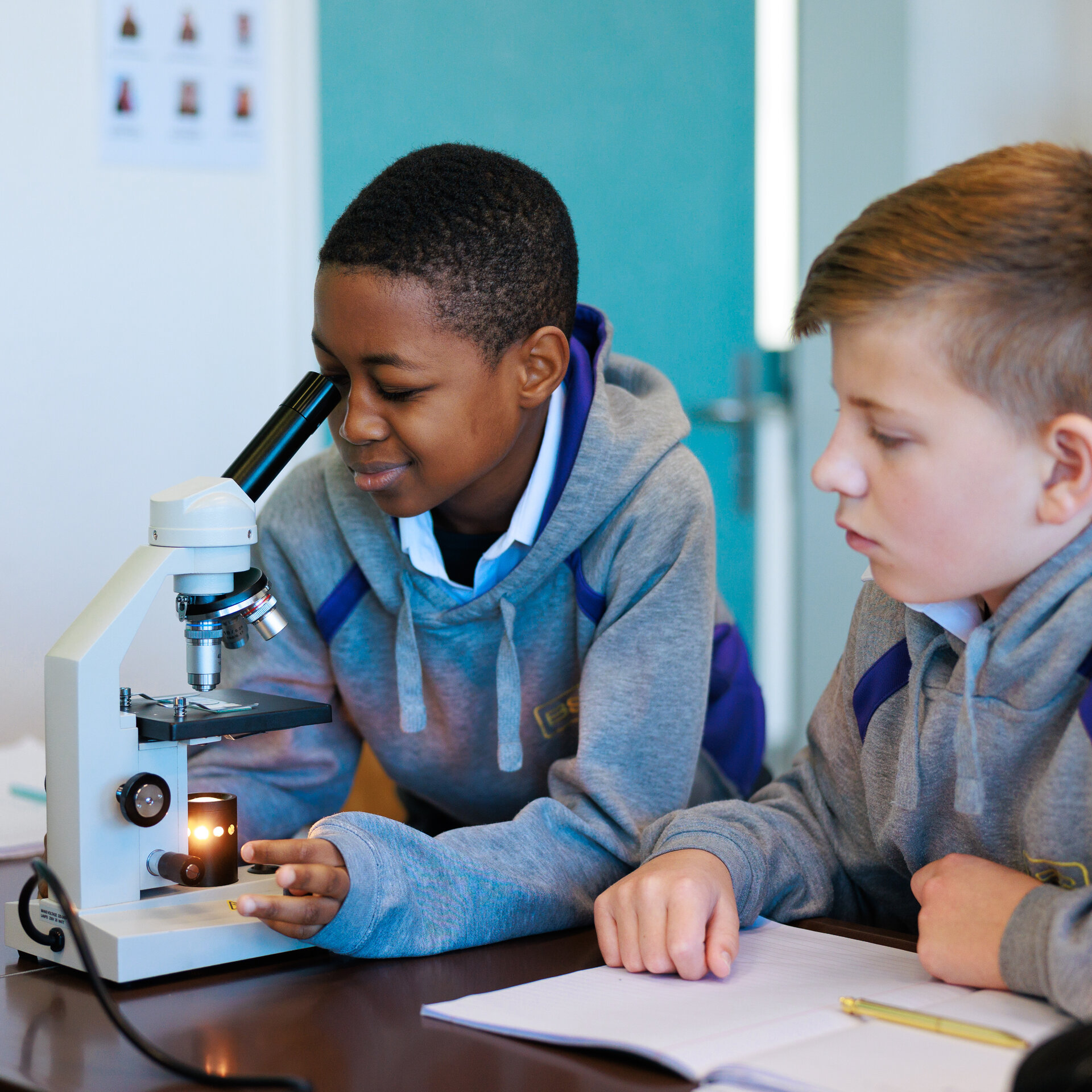 student looks through microscope