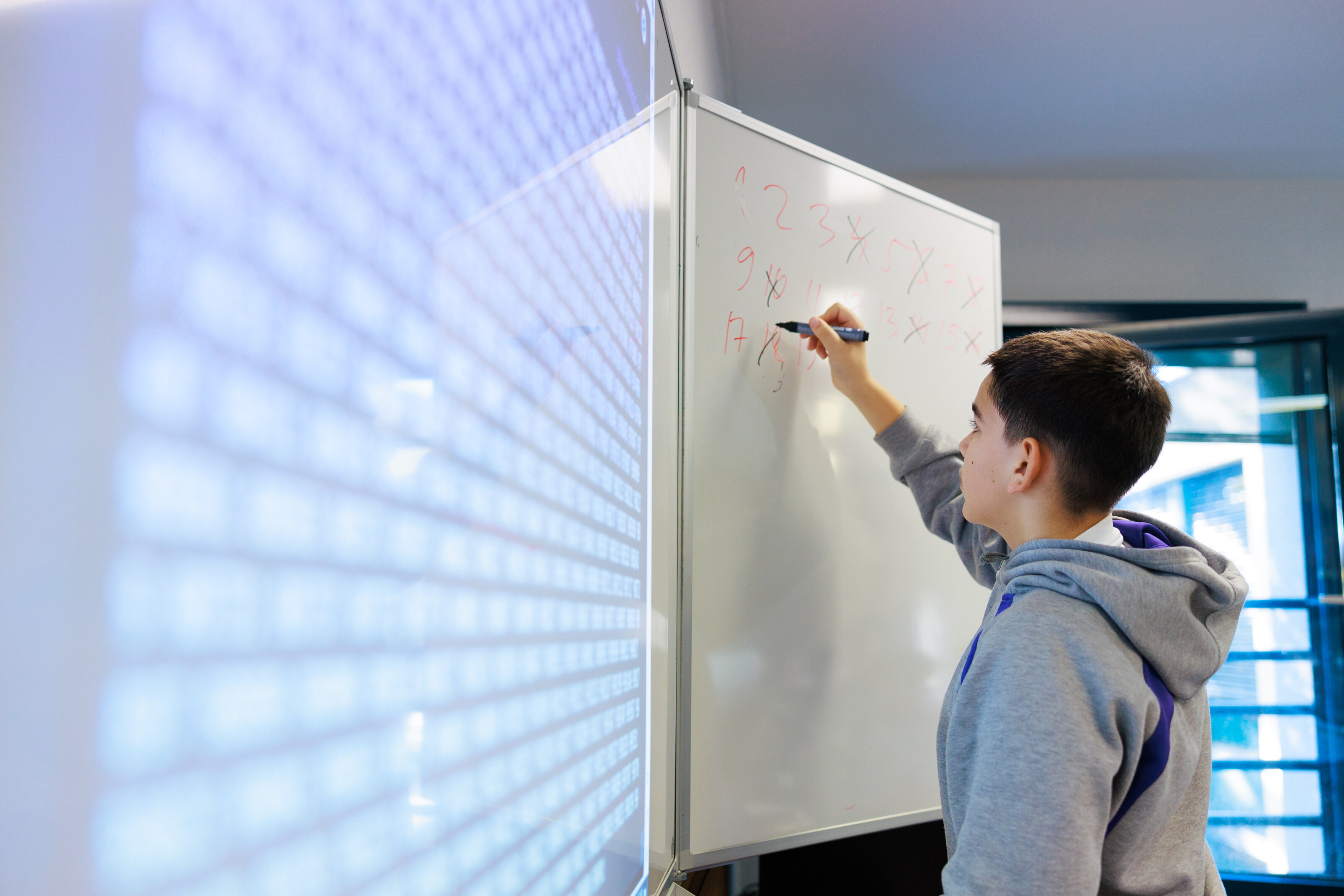 student writing on a whiteboard