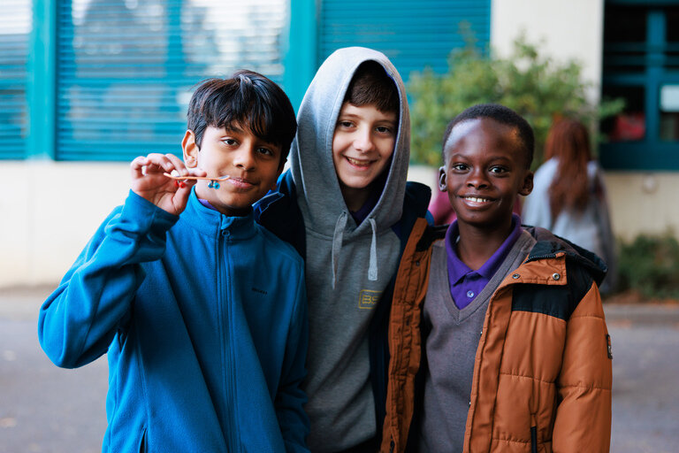 three students hugging each other